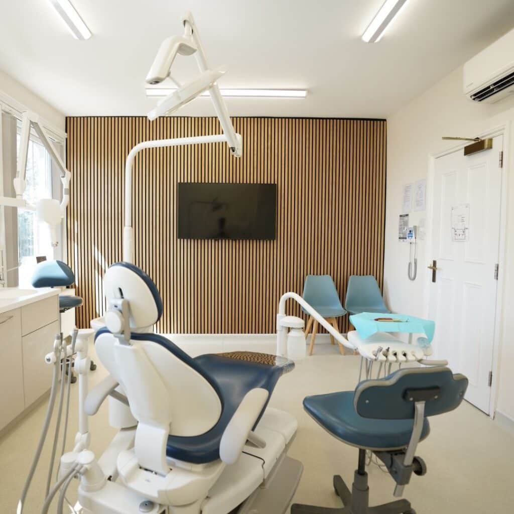 Modern dental office with blue chair and wood slat wall
